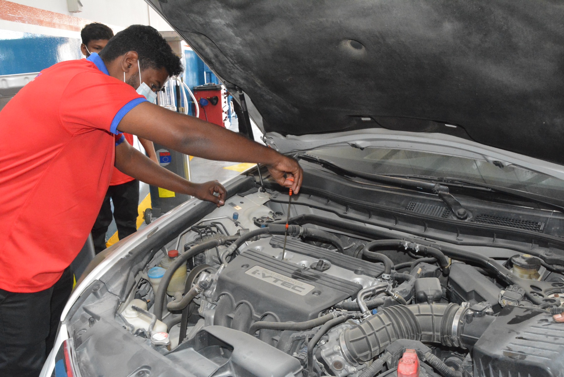 Al Bedaya mechanic working on a car engine